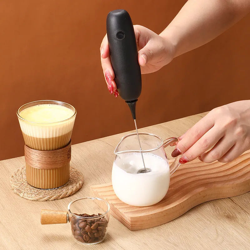 Hand-held electric milk frother in black and white colour options