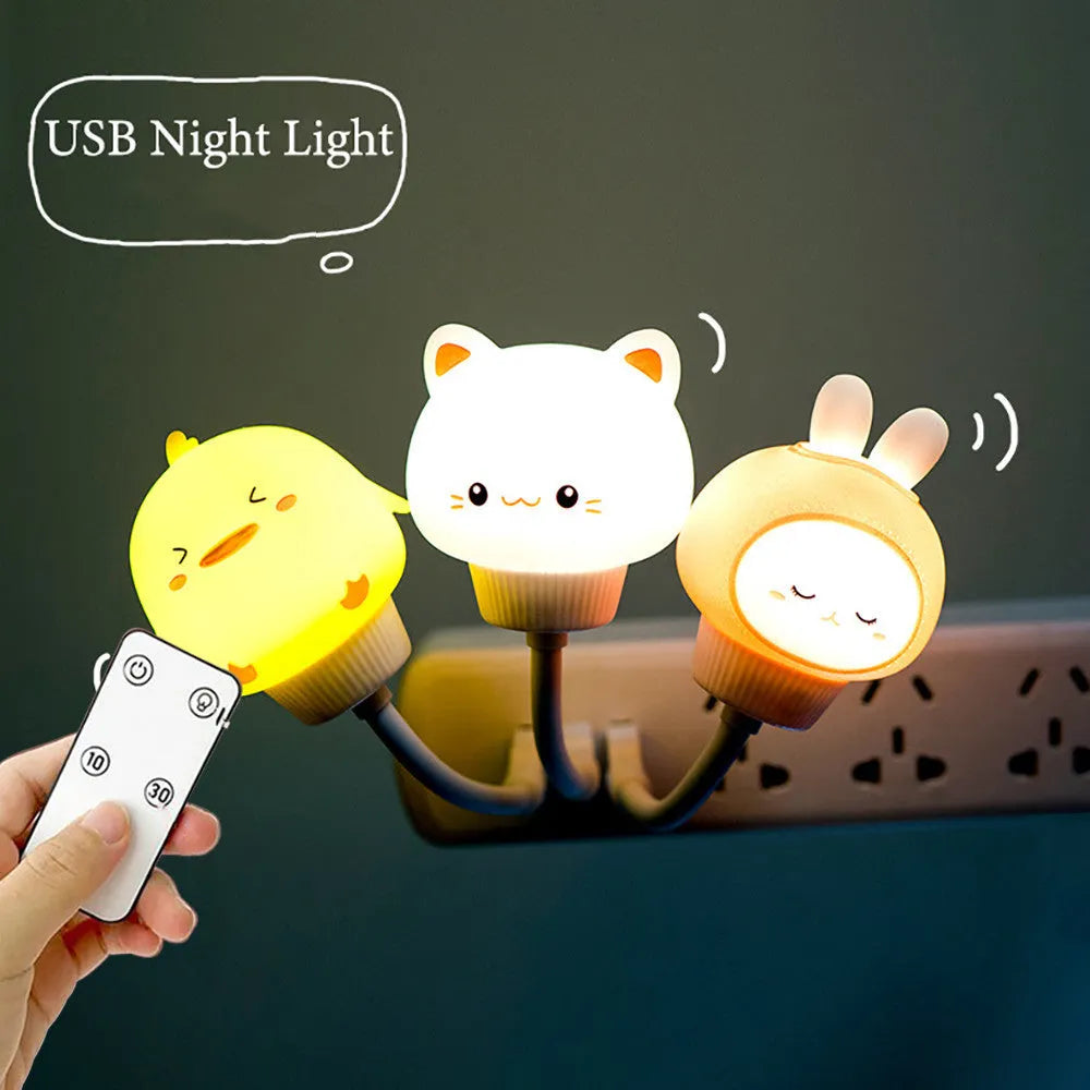 Cartoon animal USB night light with remote control on a bedside table.