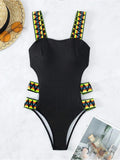 Women's solid colour one-piece swimsuit in black or orange polyester fabric
