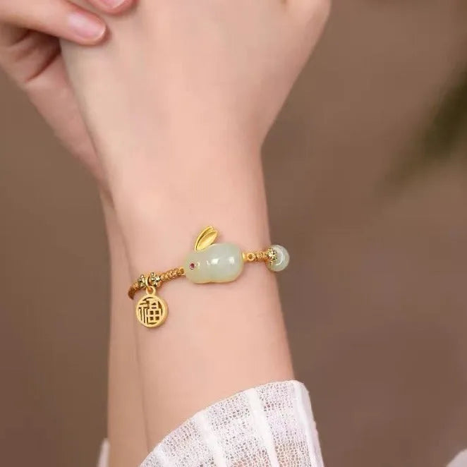 Yellow string bracelet with a geometric Hetian jade charm shaped like a rabbit for women.