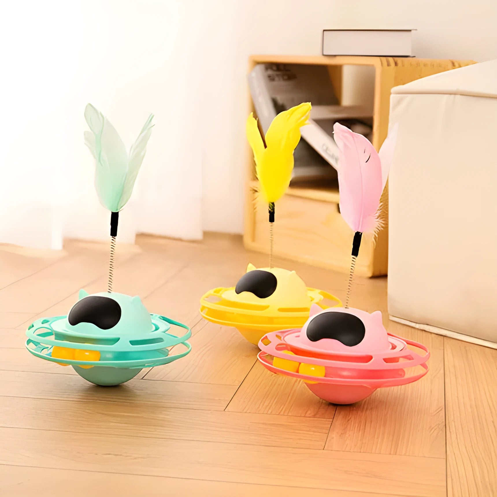 Pink cat tumble spinner toy with feather attachment measuring 17x10cm for independent feline play
