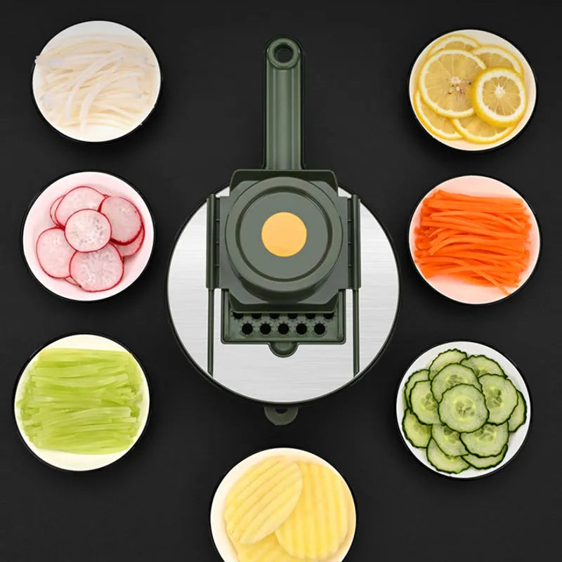 Multifunctional vegetable slicer in grey or green with five stainless steel blades, hand guard and paring knife
