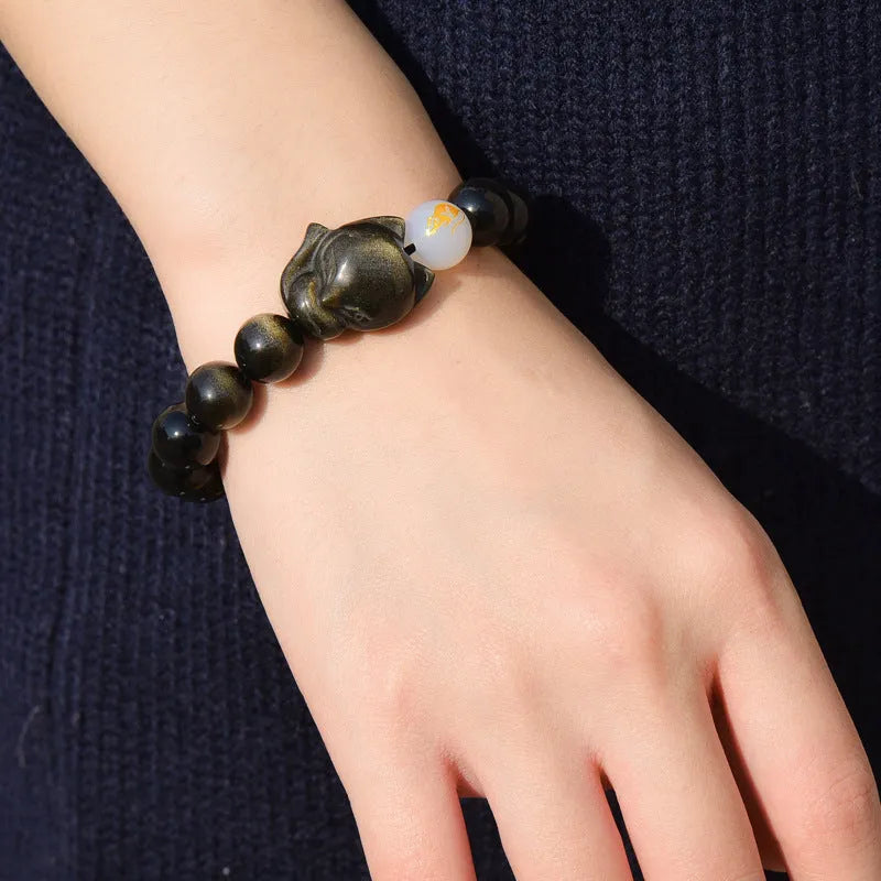 Natural obsidian bracelet with 10mm beads in gold, silver, or black finish.
