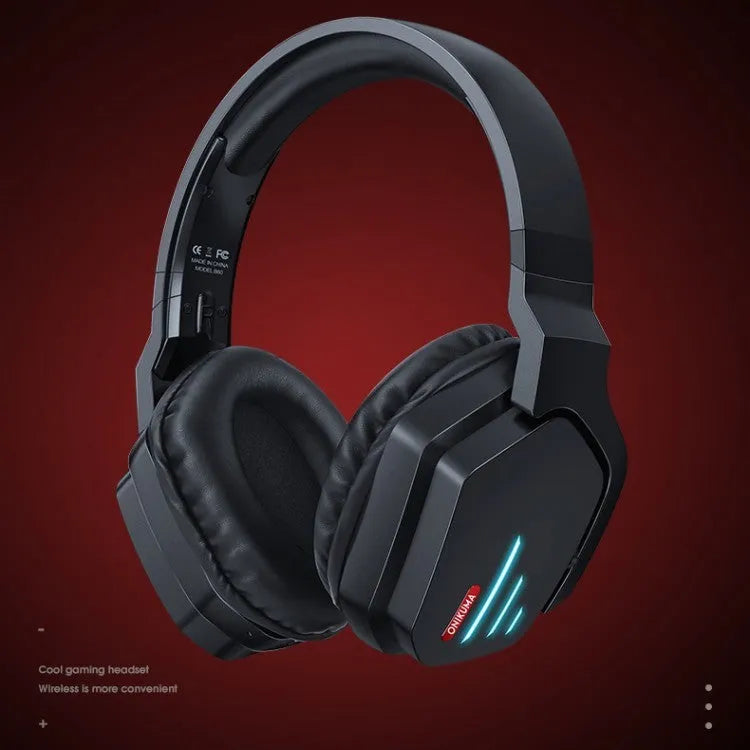 Luminous black wireless over-ear gaming headphones shown with a 3.5mm audio cable and dust bag.