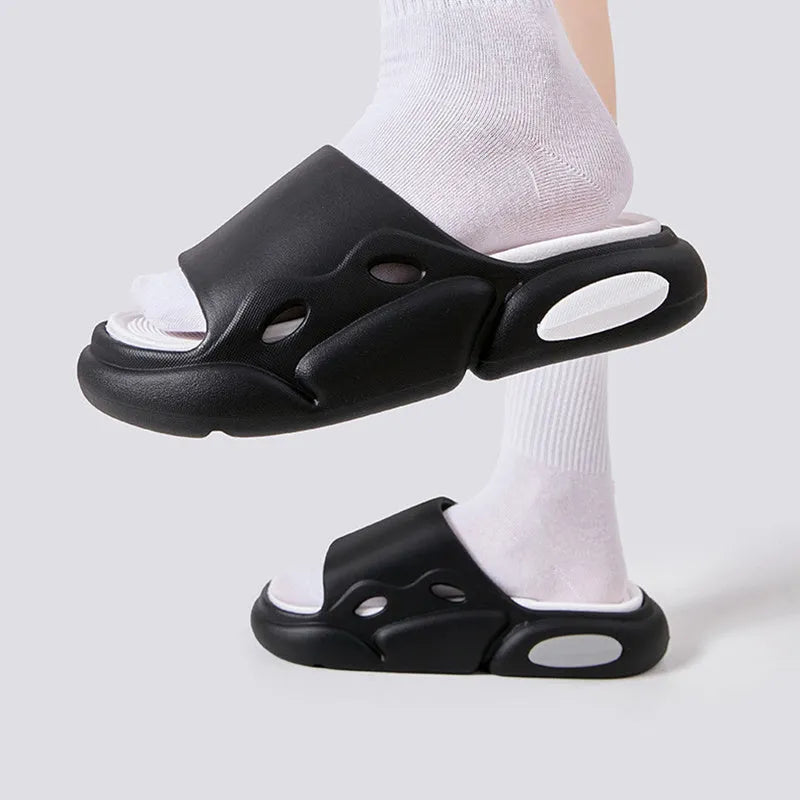 Women's two-colour EVA foam slippers with thick sole in pink and purple, shown on a foot.