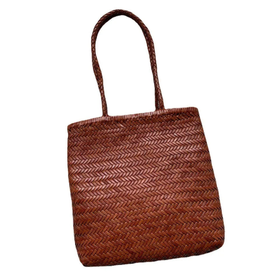 Brown woven genuine leather tote bag with a three-dimensional front pocket.
