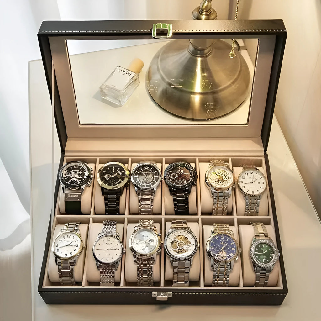 Grey leather watch storage box with transparent lid showing internal watch slots.