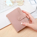 Ladies' short PU leather wallet with a lychee pattern, shown folded, in beige, pink, black, and red colour options.