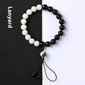 Handmade retro bracelet with White Corypha Umbraculifea Blackwood and Mixed Yuan Beads on a lanyard.