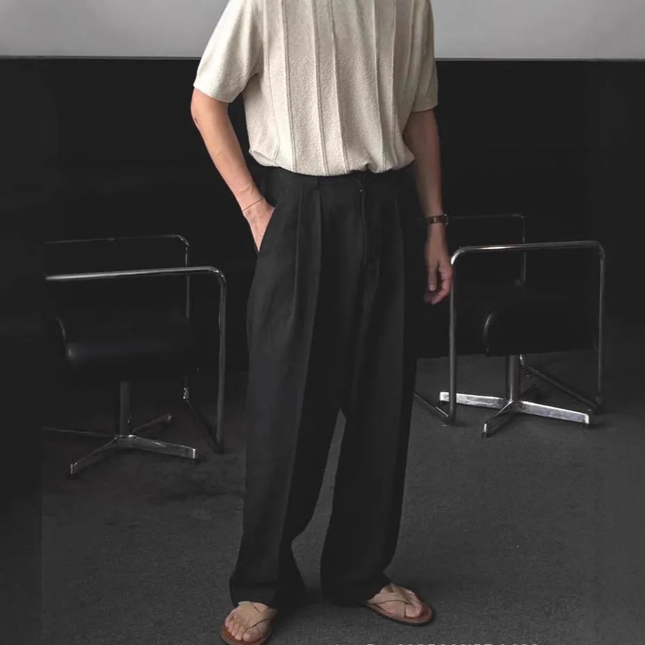 Men's apricot-coloured wide-leg cotton linen trousers with an elastic waistband on a hanger.