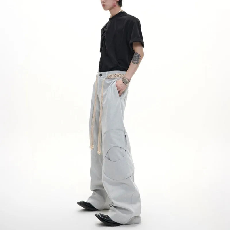 Men's dark blue loose straight-leg jeans with tassel decoration and front zipper placket.
