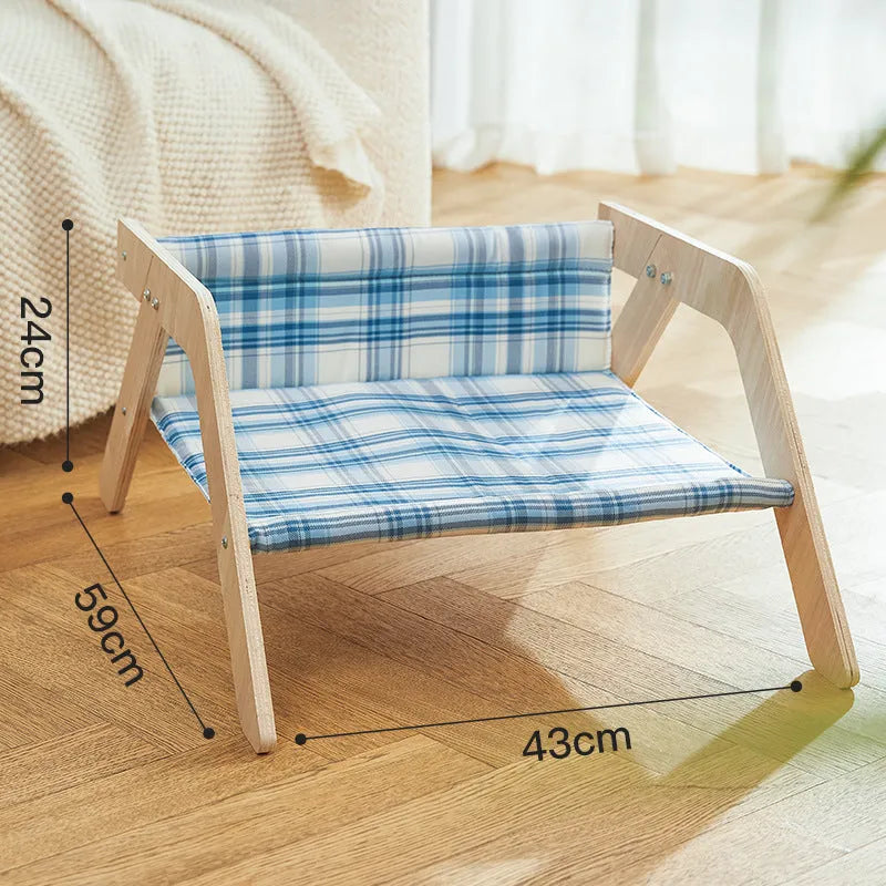 Wooden elevated cat bed with blue cloth hammock for indoor feline lounging