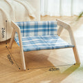 Wooden elevated cat bed with blue cloth hammock for indoor feline lounging