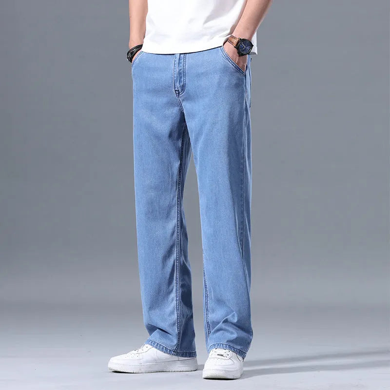 Men's loose straight-leg lyocell jeans shown in light blue colour with a zipper fly.