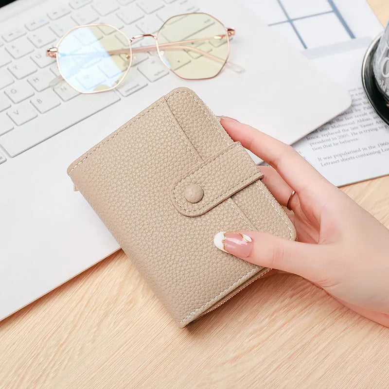 Ladies' short PU leather wallet with a lychee pattern, shown folded, in beige, pink, black, and red colour options.