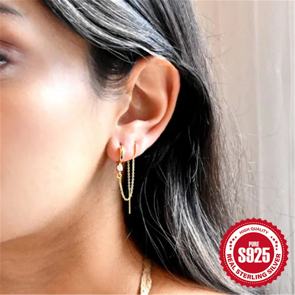 S925 sterling silver ear stud with a geometric diamond flower design and delicate tassel chain detailing in a gold tone finish.