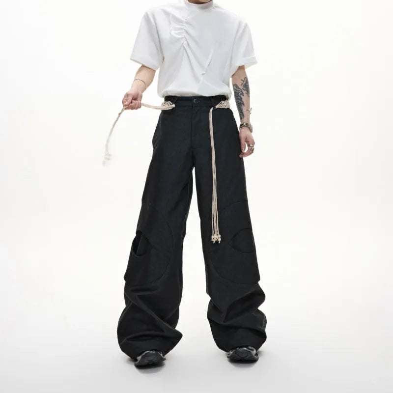 Men's dark blue loose straight-leg jeans with tassel decoration and front zipper placket.