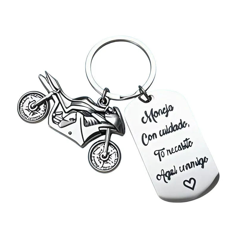 Stainless steel motorcycle key chain with charm and grey flannel storage bag.