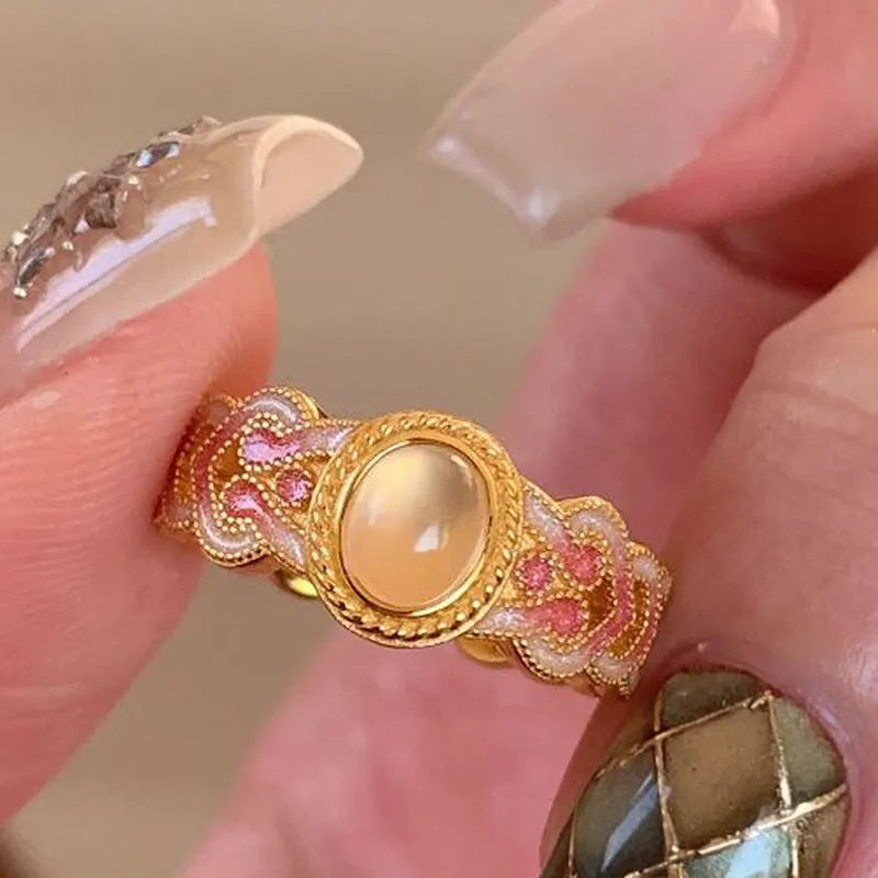 Pink crystal enamel geometric open ring on a gold plated copper band for women.