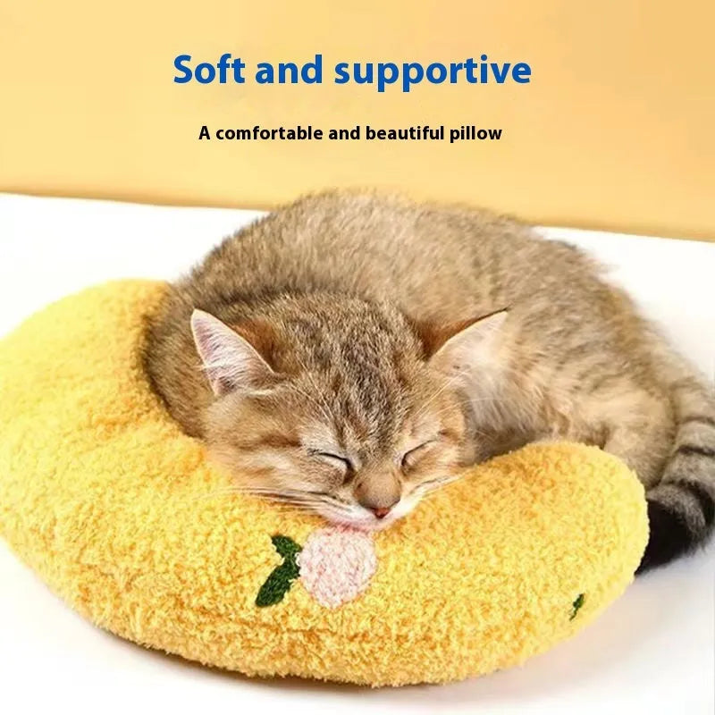 Blue U-shaped cat neck protection pillow on pet bed