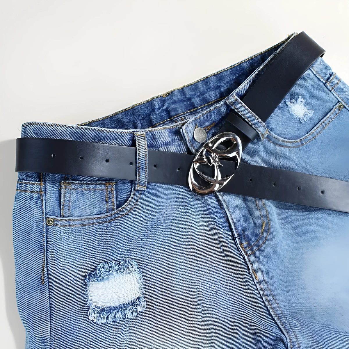 Silver buckle on a brown PU leather casual belt with snap button closure