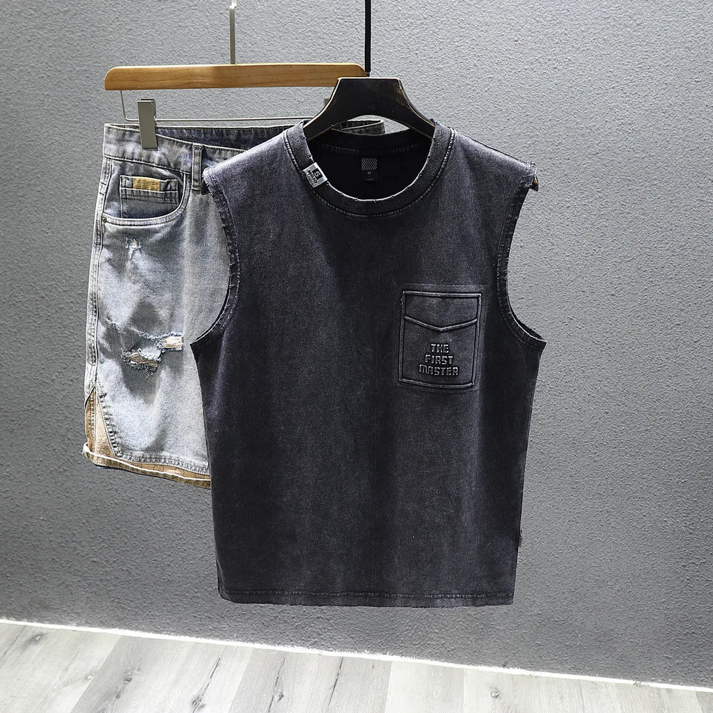 Loose fit cotton sleeveless t-shirt in black on a hanger, showing straight hem design.