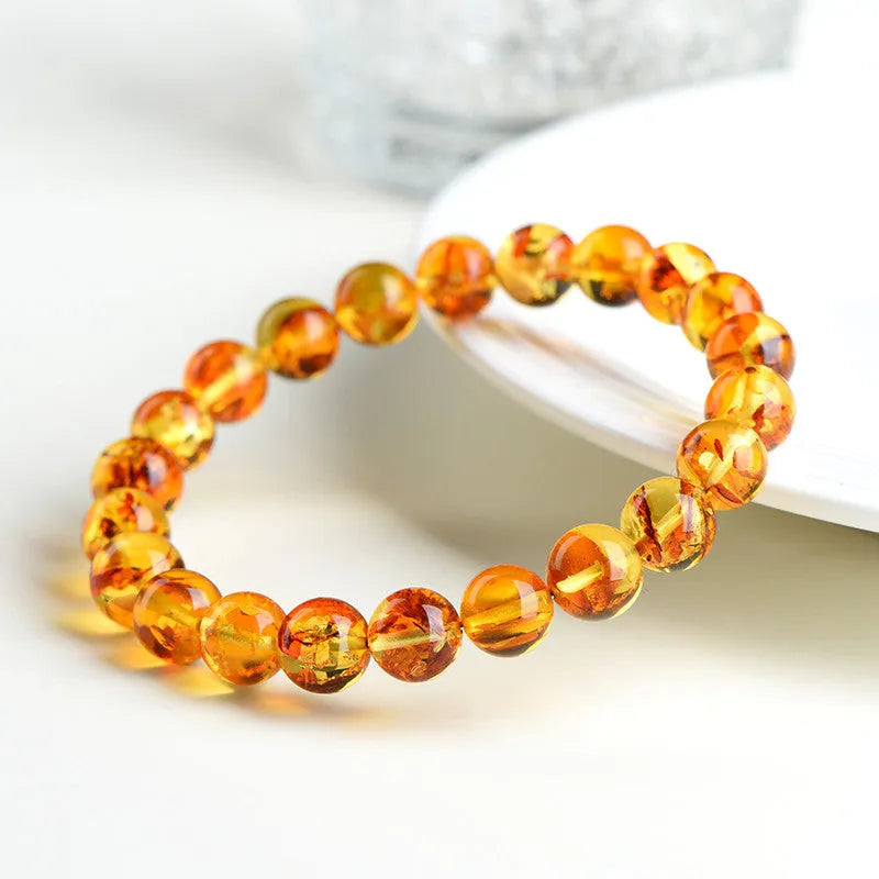 Natural yellow piebald amber bracelet with geometric beads in polished finish