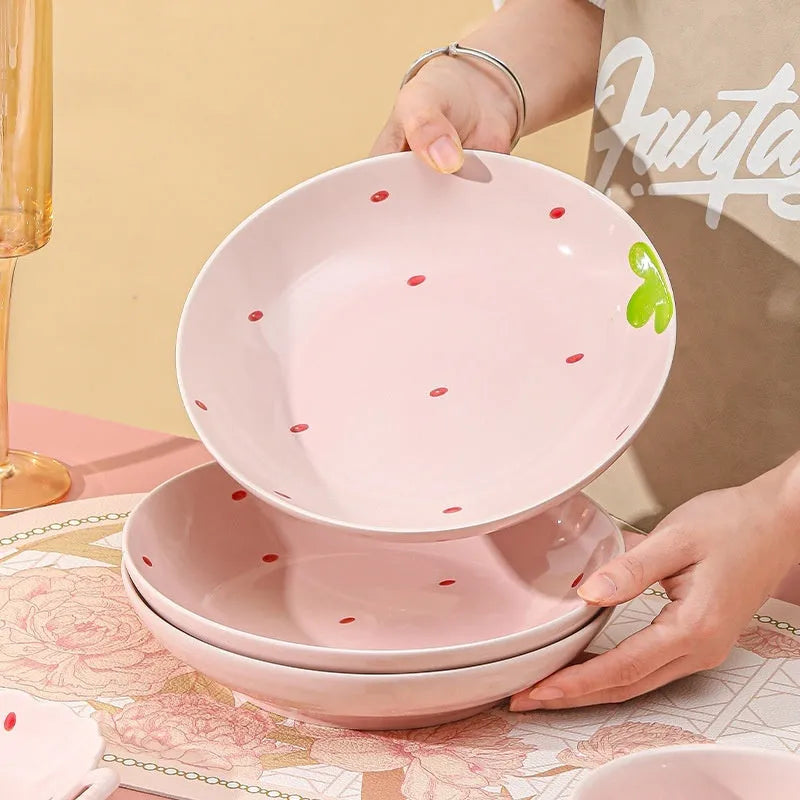 Porcelain dinnerware set with cute strawberry design showing straw hat plate, flower bowl, and twist spoon