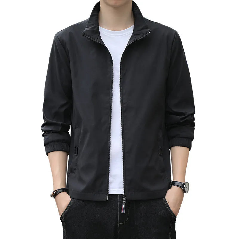 Man wearing a loose fit black Korean style casual jacket with zip pockets.