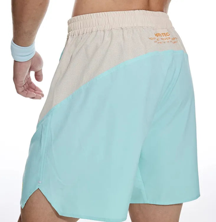 Men's loose grey workout shorts with elastic waist and lace-up fly detail for gym training.