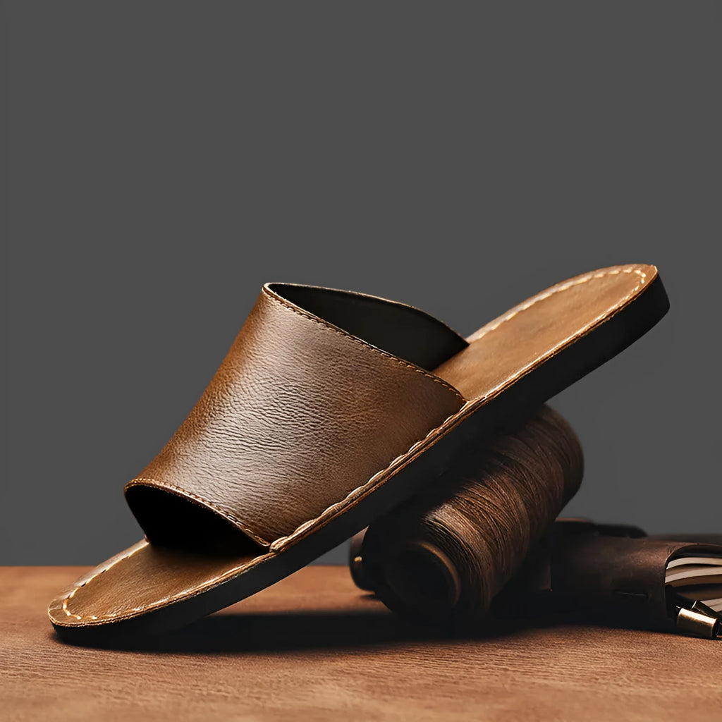 Brown leather men's open-toe sandals with a rubber sole on a neutral background.