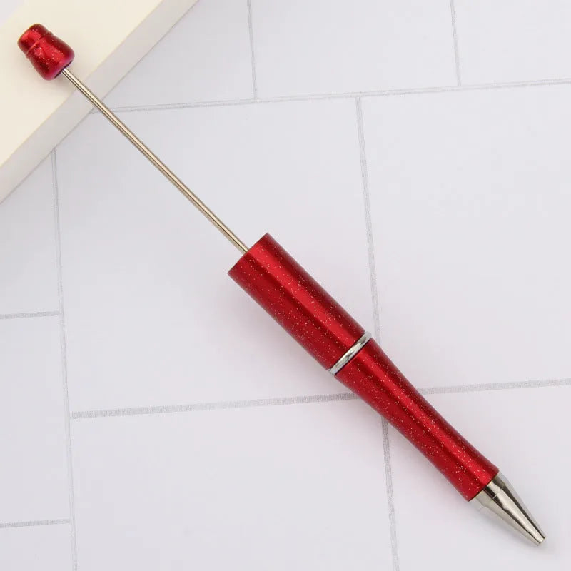 Ballpoint pen with colourful spinning plastic beads on barrel, shown in a gradient purple finish.