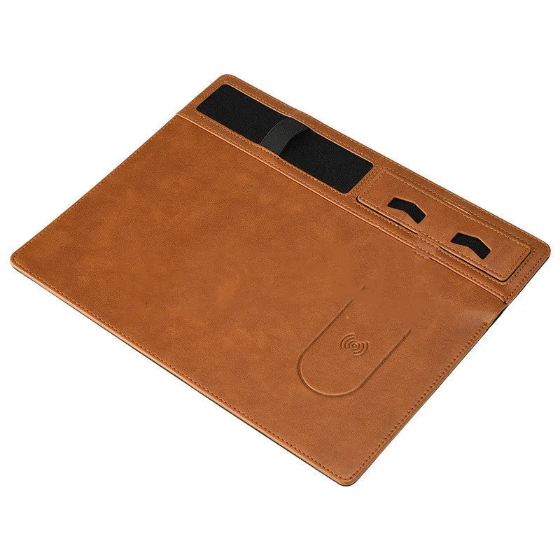 Pink multifunctional wireless charging mouse pad with integrated mobile phone holder on a desk