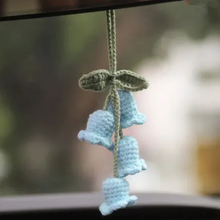 Green and white knitted wool car plant decoration with plastic base and hanging rope