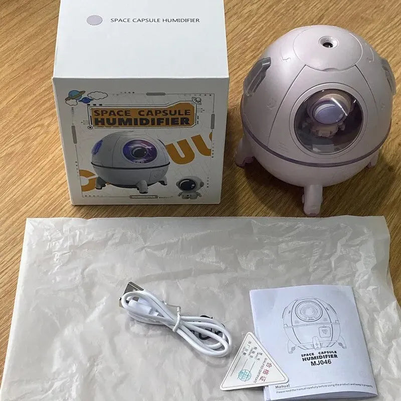 Light purple astronaut-shaped USB humidifier with 220ml tank and colourful LED light on desktop