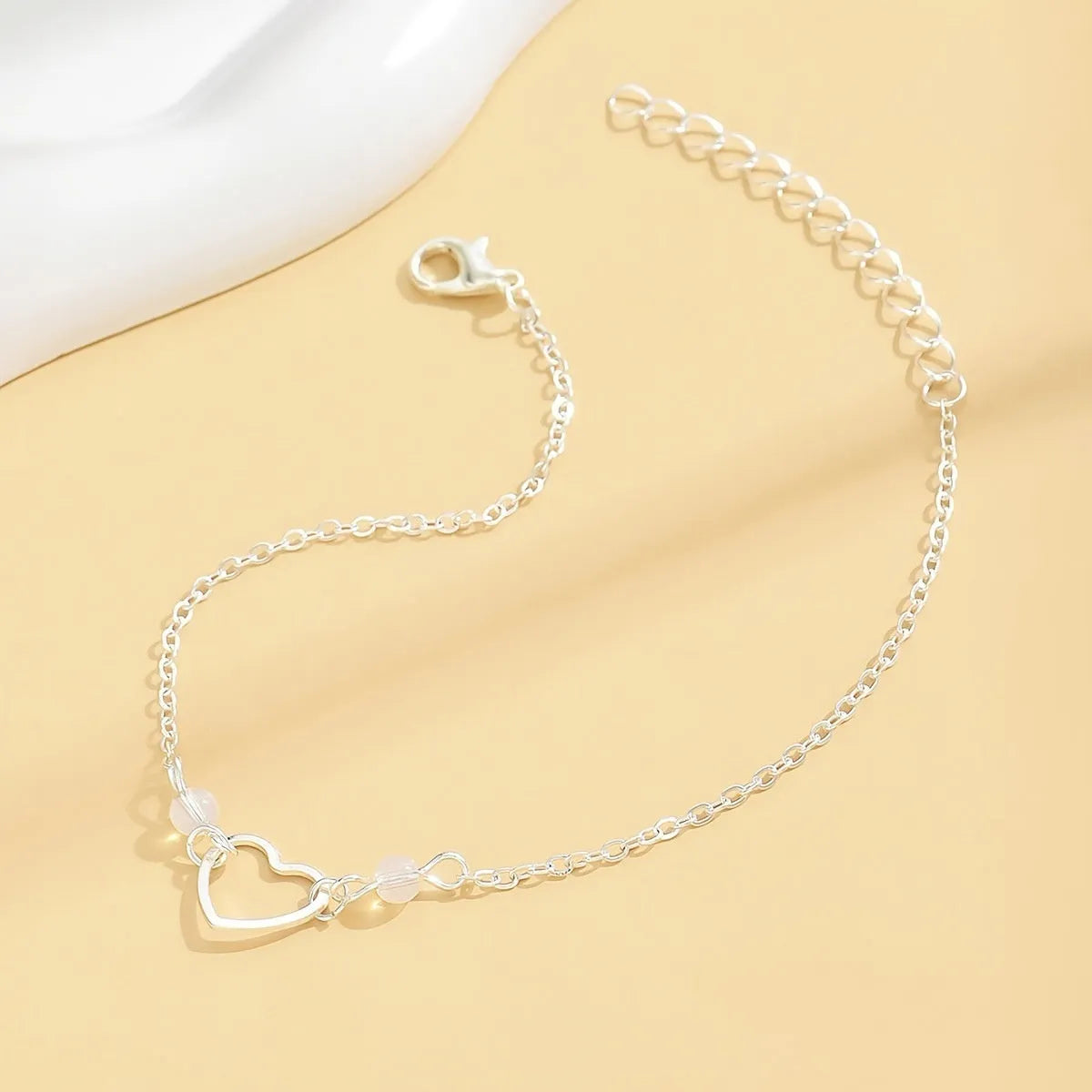 Women's adjustable anklet with heart pendant in gold or silver alloy