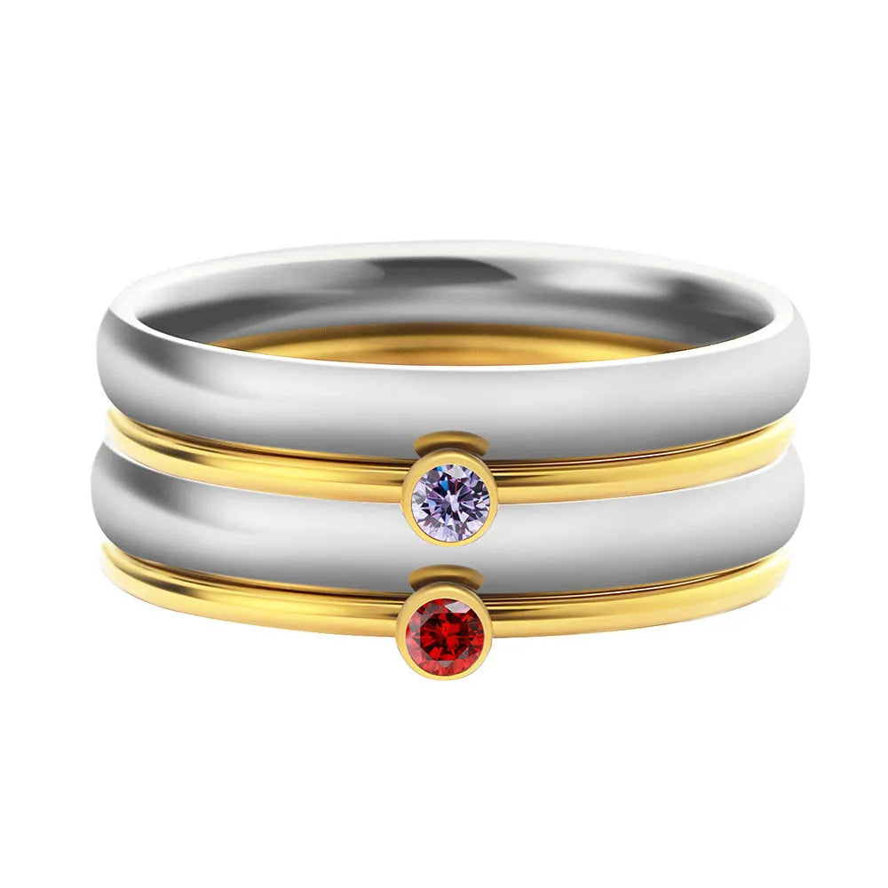 Women's titanium steel ring with engraved geometric December birthstone design on a finger.
