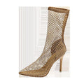 Gold mesh high heel sandals with pointed toes and stiletto heels on a rubber sole.