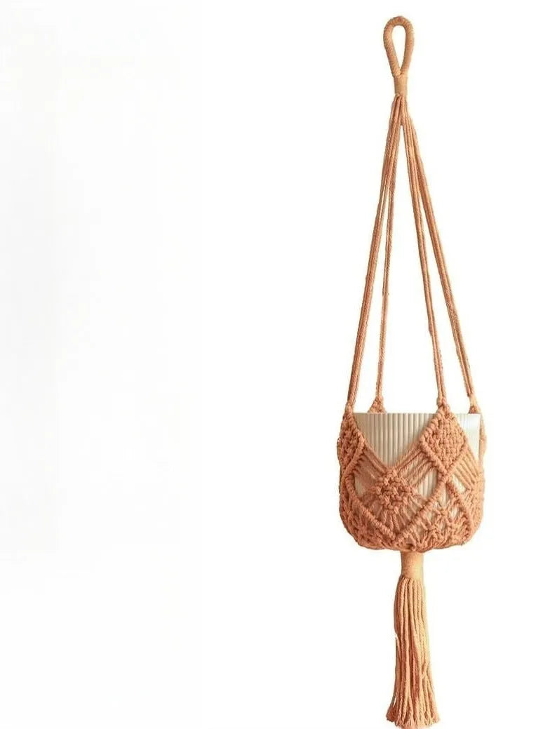 Hand-woven brown polyester cotton net pocket extension cord on a grey flower pot.