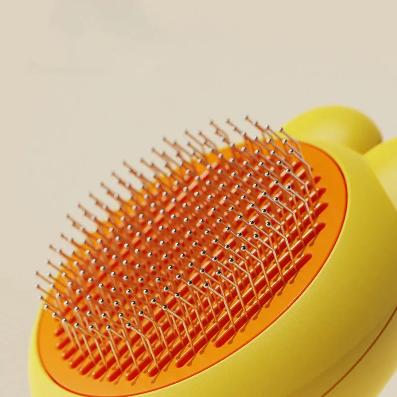 Green self-cleaning pet grooming brush with metal comb and comfort-grip handle on a wooden table.