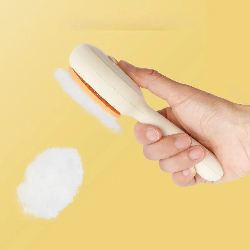 Yellow stainless steel cat grooming brush with non-slip handle for hair removal.