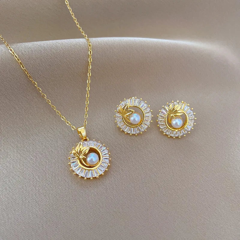 Women's geometric jewellery set with titanium steel necklace, copper pendant, and matching stud earrings.