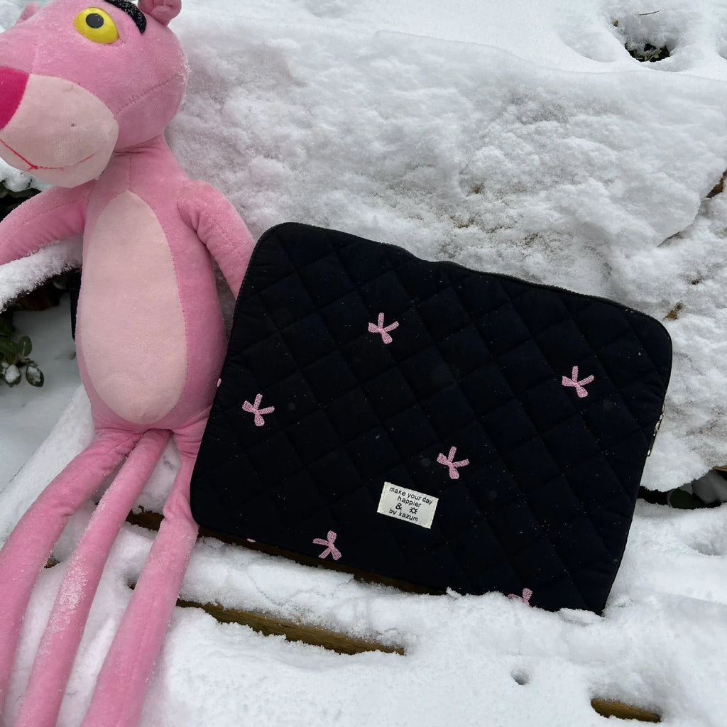 Nylon laptop storage bag with a rhombus-shaped embroidered bow on the front.