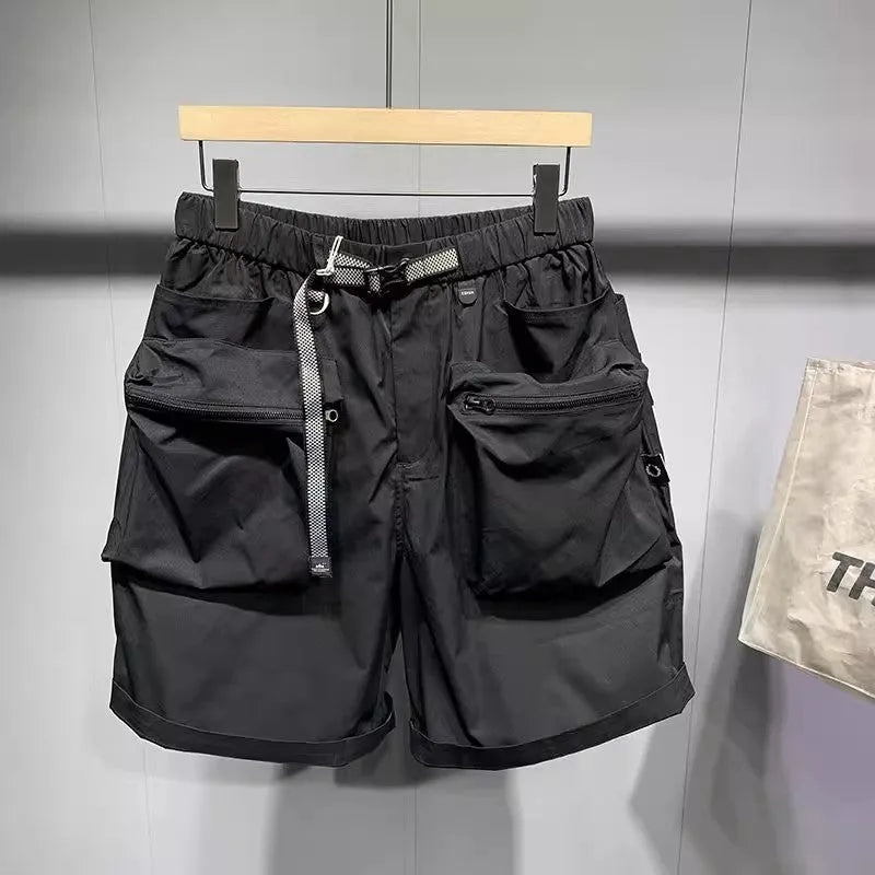 Men's loose fit grey workwear shorts with pockets, shown above the knee.