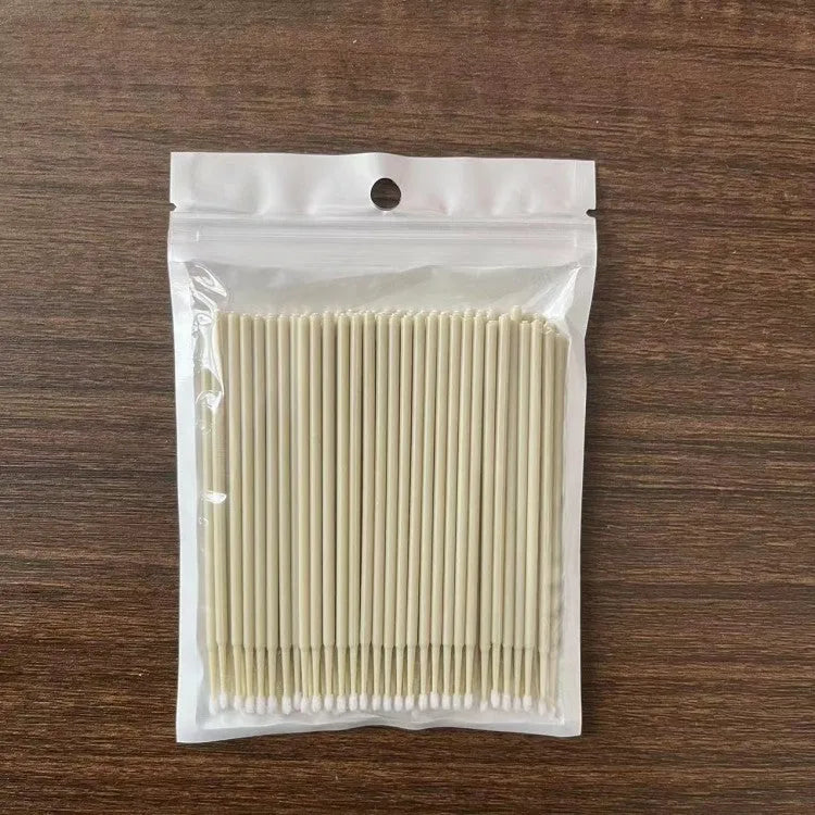Disposable micro applicator brushes with bendable cotton tips and colour-coded handles for eyelash extensions