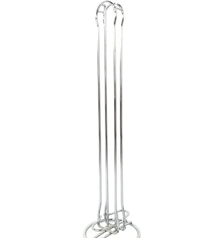 Black wrought iron coffee capsule storage rack holding pods on display shelves.