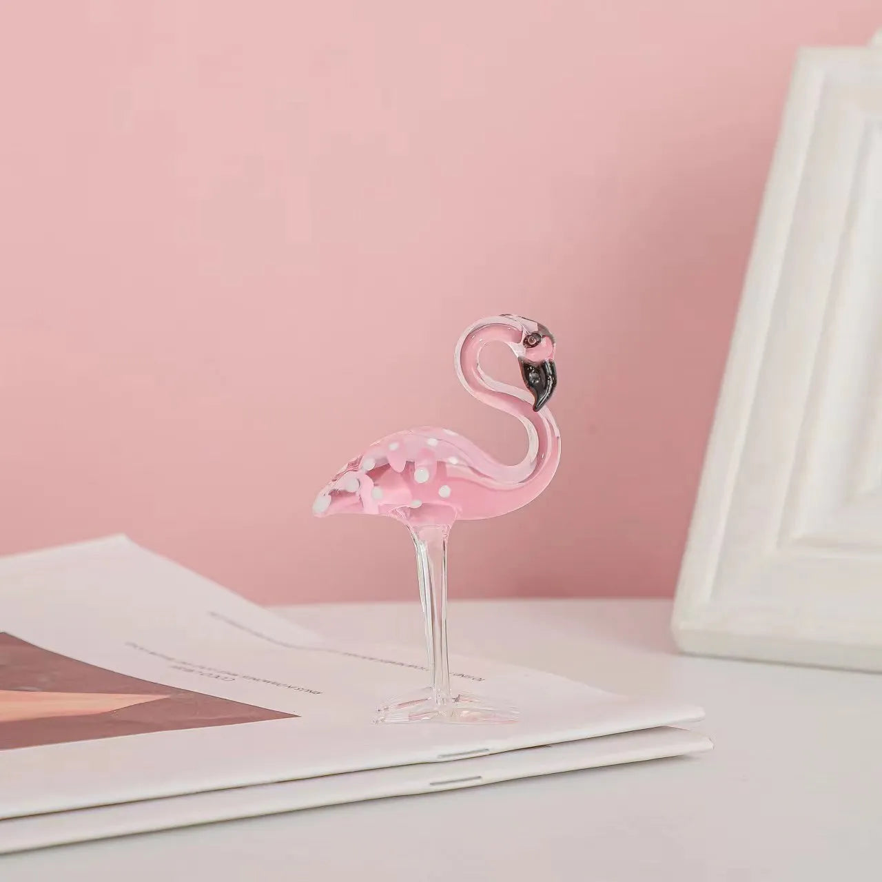 Pink and white crystal decorative flamingo table prop on a modern shelf