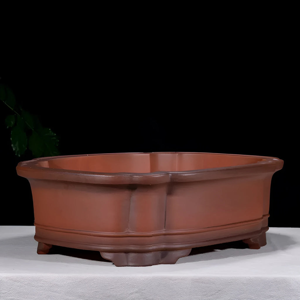 Large antique-finish Chinese purple clay flower pot with decorative tree stump and floral motifs.