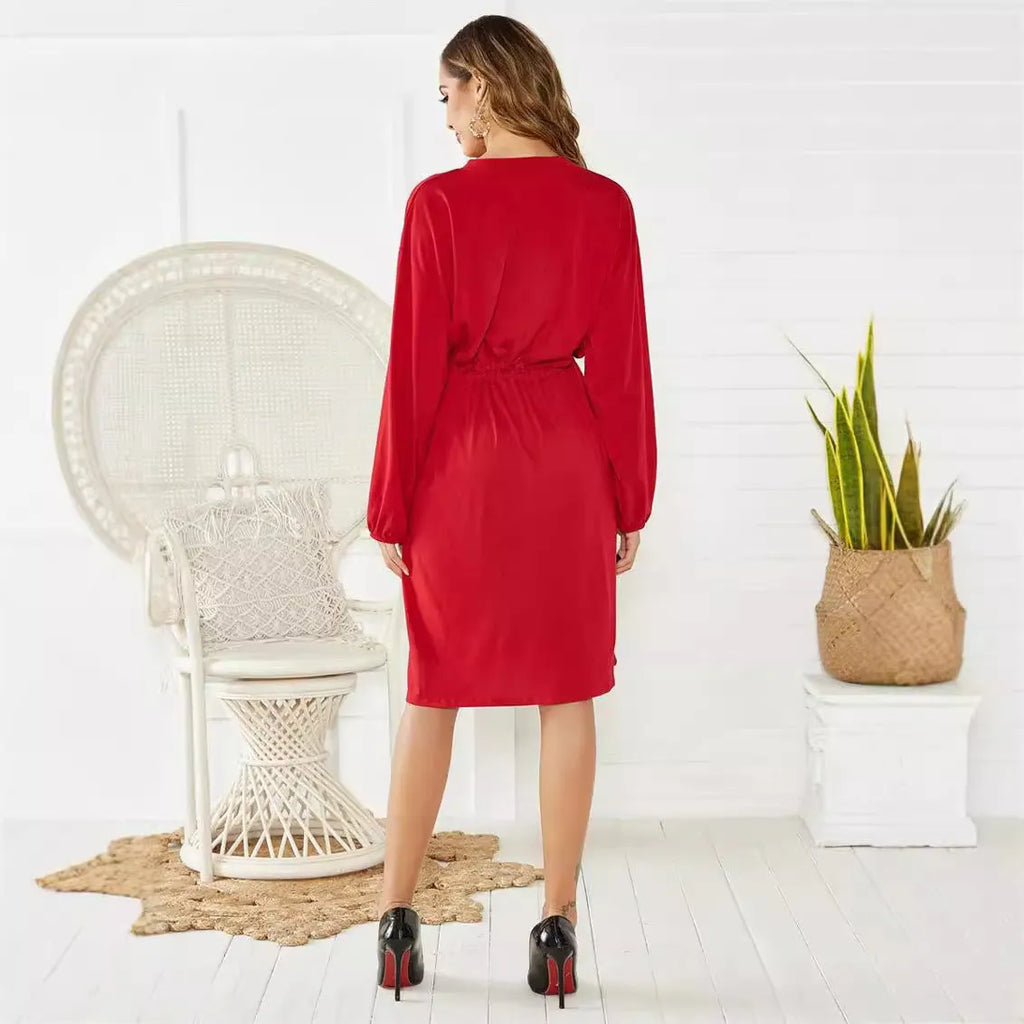 Women's loose elastic belt cinched short dress in solid black or red polyester with long sleeves and A-line skirt