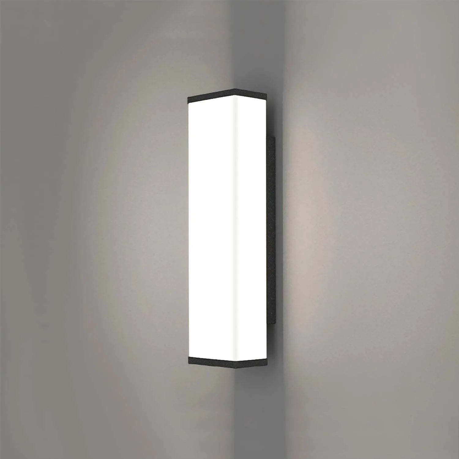 Long, slim stainless steel and plastic outdoor wall light mounted on a brick wall.